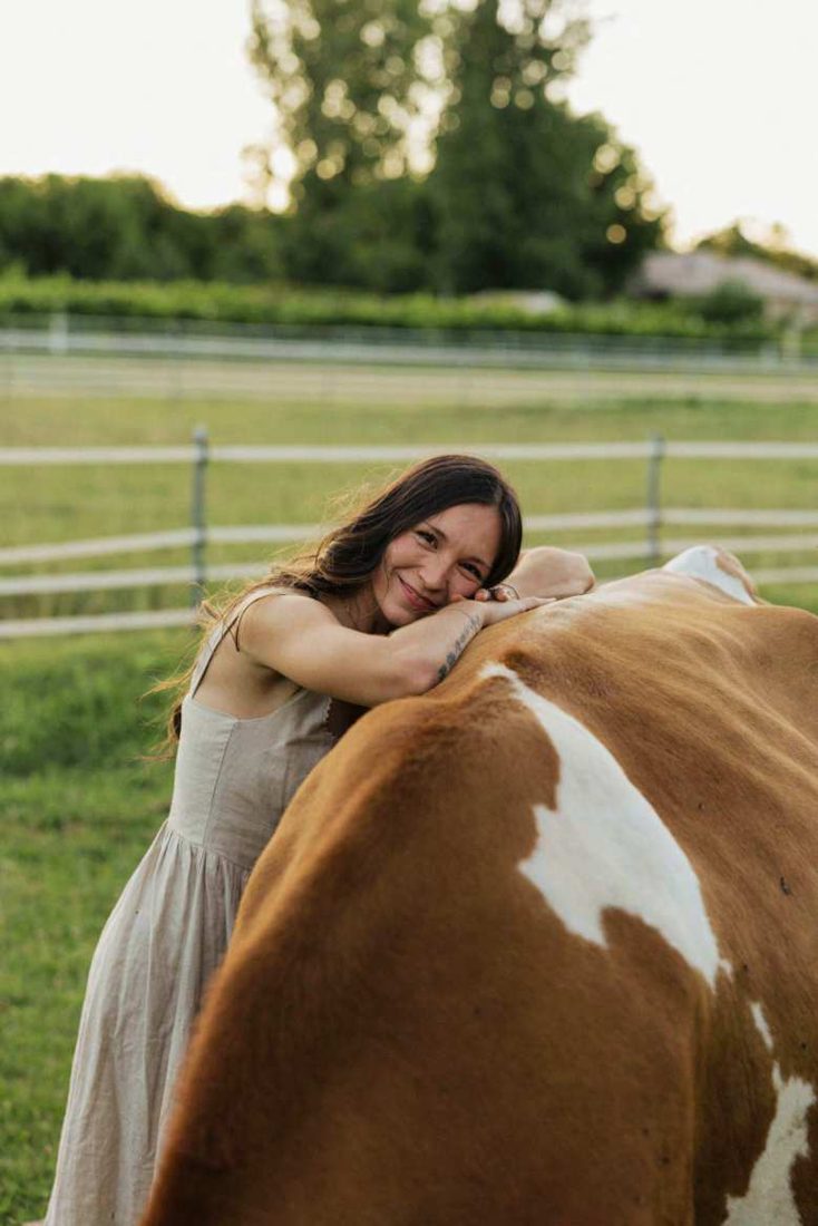 Selina of Milkmaid Farm smiling with her cow