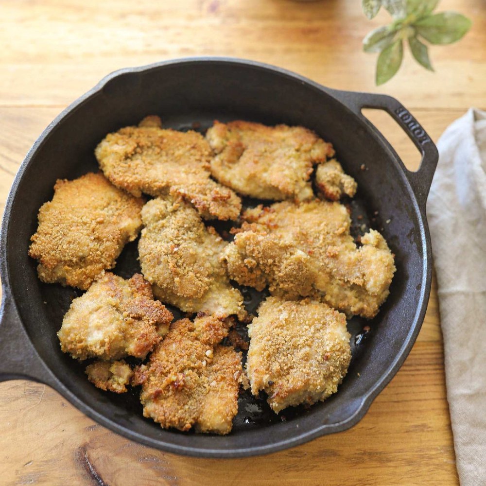 Homemade chicken tenders in a cast iron skillet