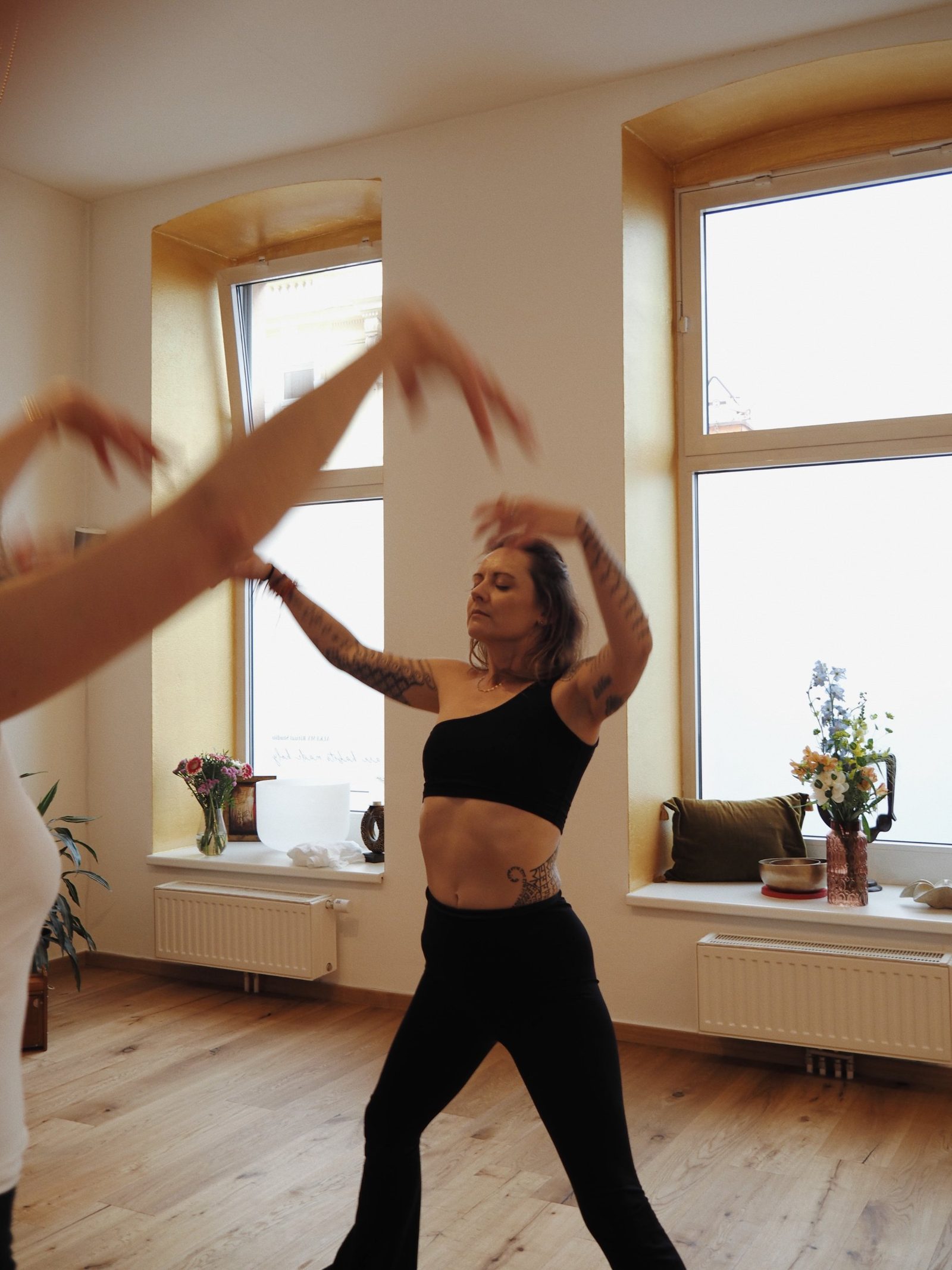Alexia dancing in the studio with golden windows