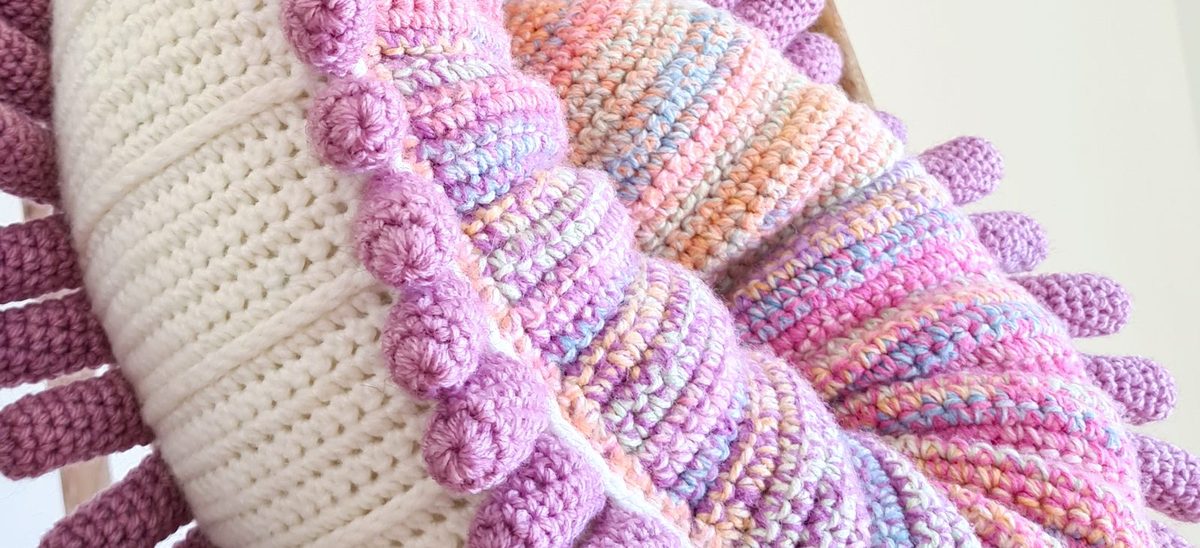 Close-up of neat crochet stitches on a rainbow nautilus
