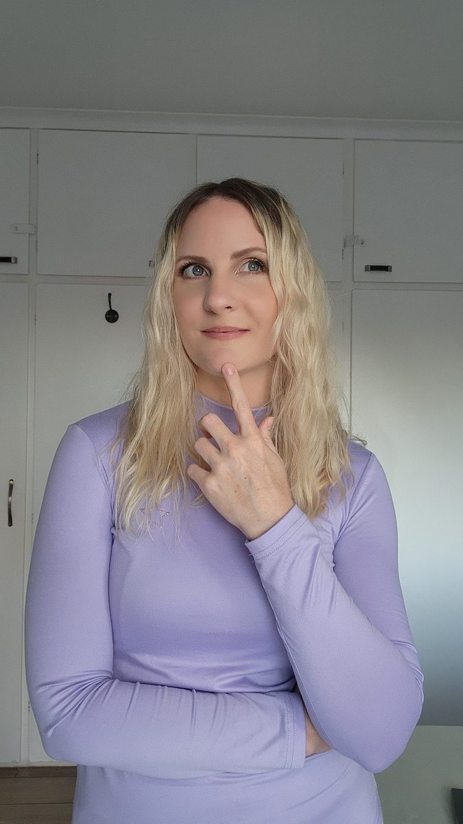 Jessie looking up thoughtfully with a finger on her chin