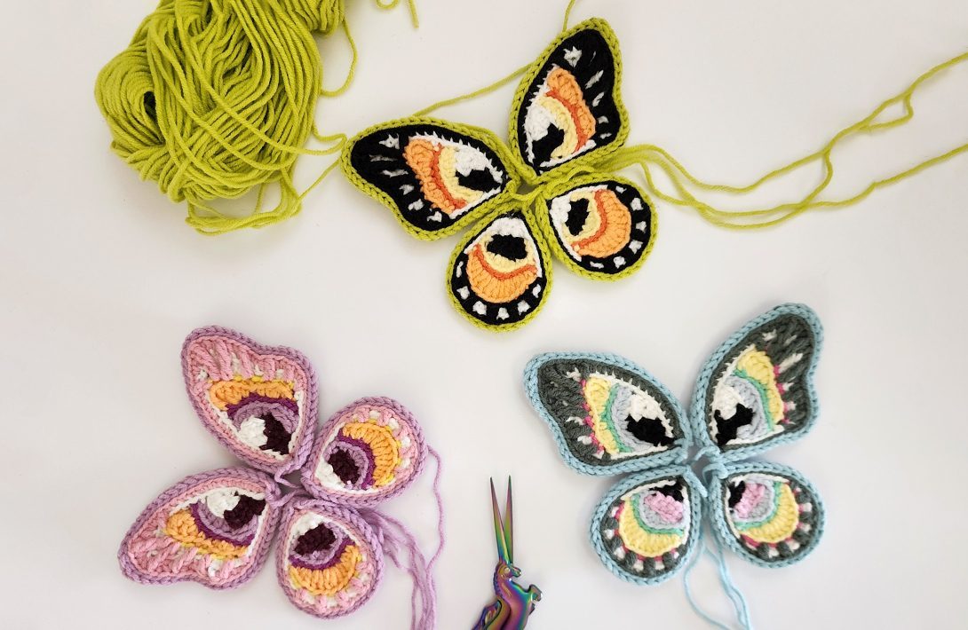 Crocheted butterflies with yarn and scissors
