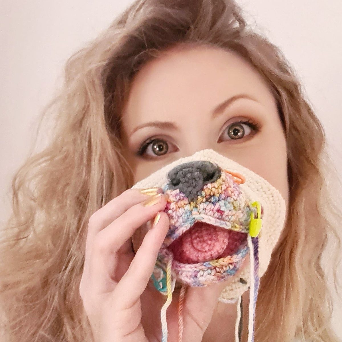 Jessie peeking over one of her crocheted hippo heads