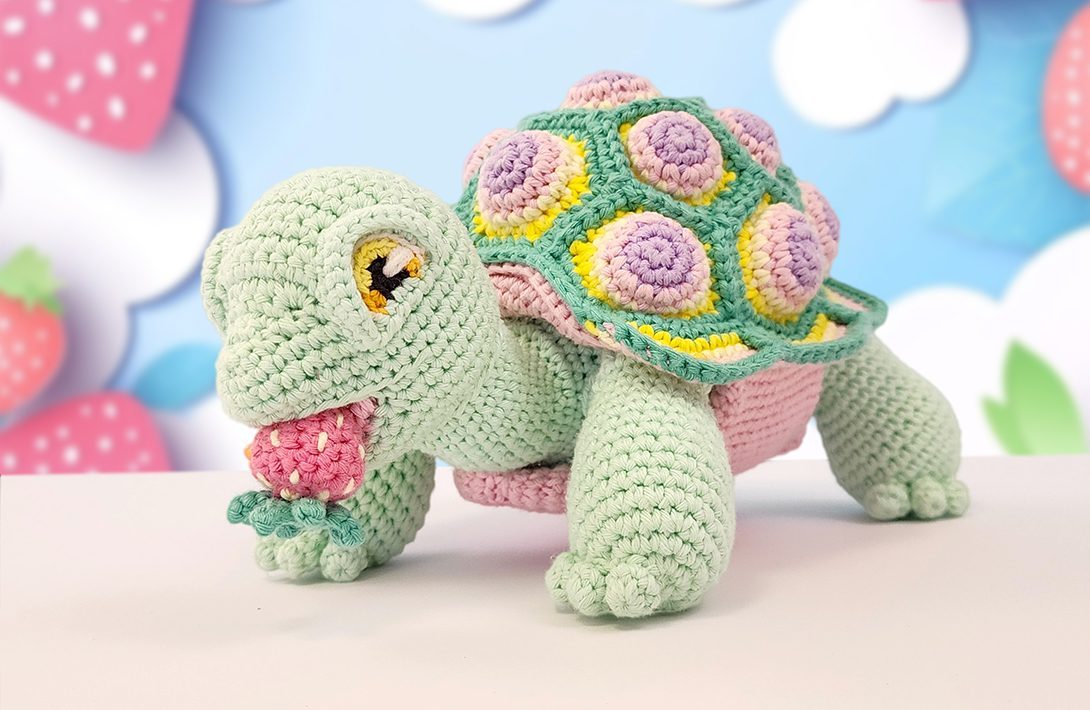 A crocheted tortoise with a patterned shell