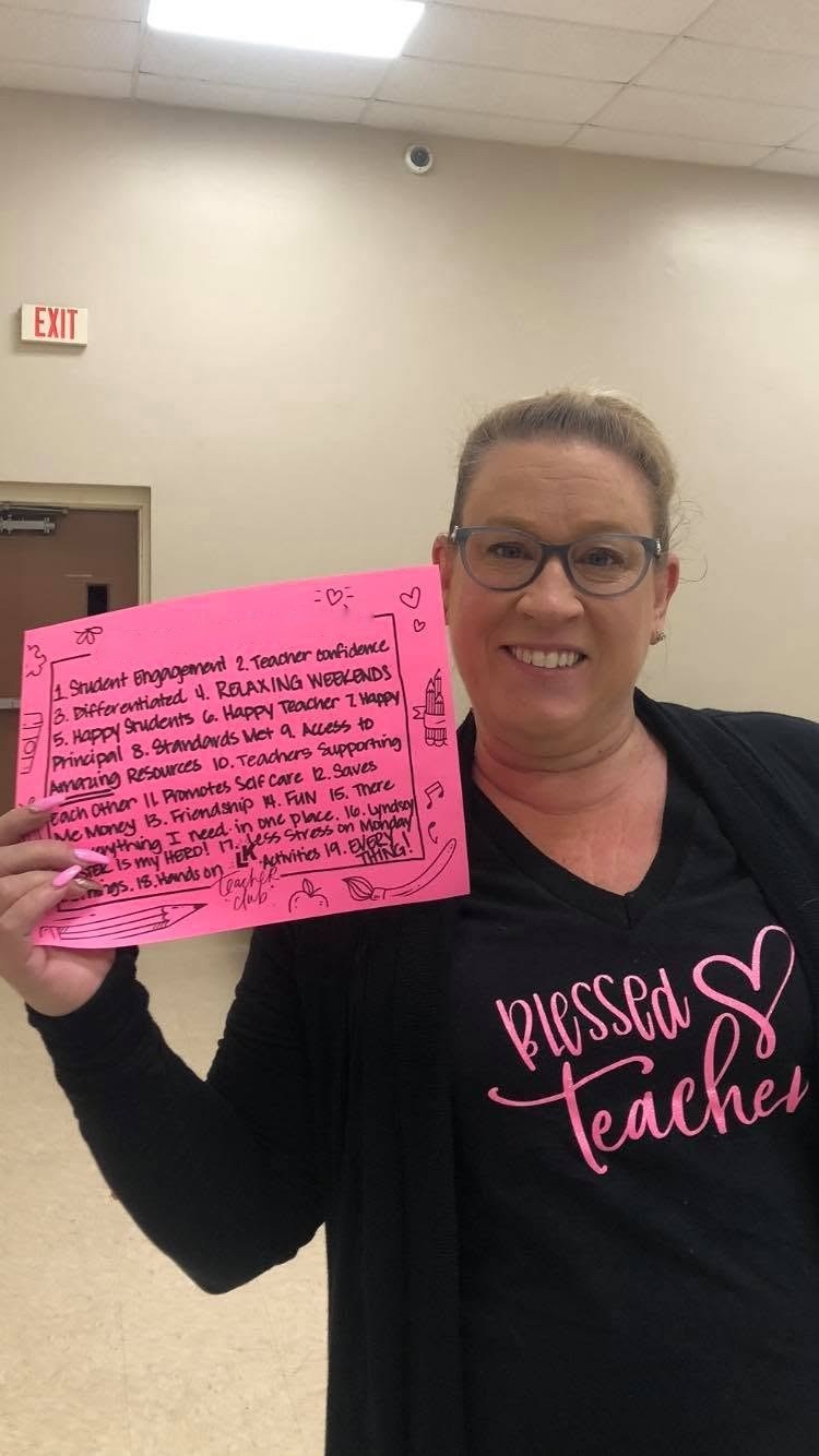 Jennifer holding a handwritten #teacherclublove sign
