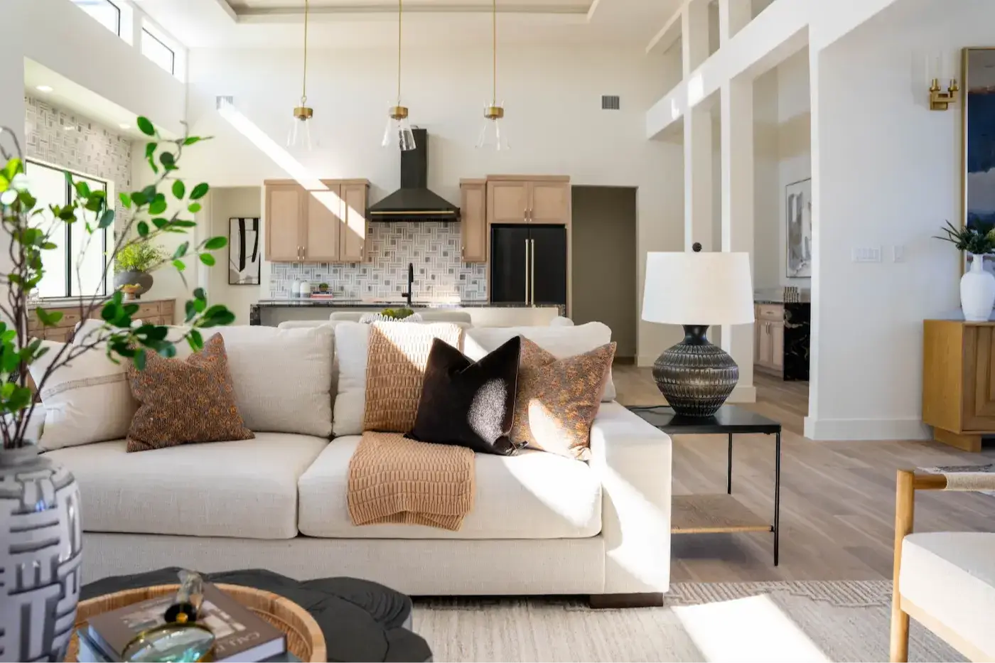 Professionally staged living room featuring neutral furnishings, layered textures, and a balanced furniture arrangement.