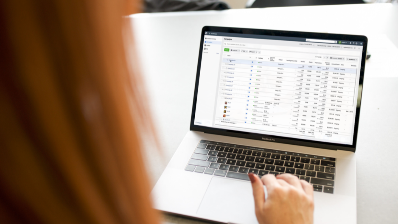 Small business owner reviewing Meta Ads campaign performance on a laptop dashboard.