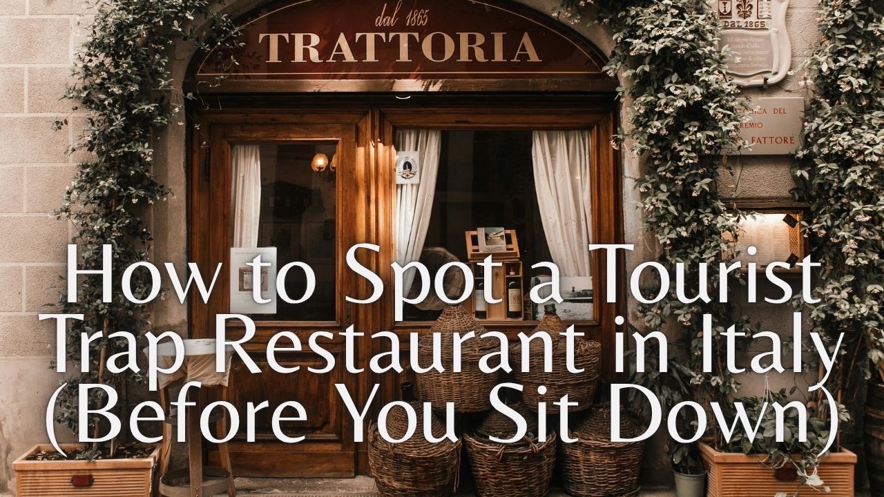 Traditional Italian trattoria entrance with wooden doors, climbing vines and wicker wine jugs, titled “How to Spot a Tourist Trap Restaurant in Italy”