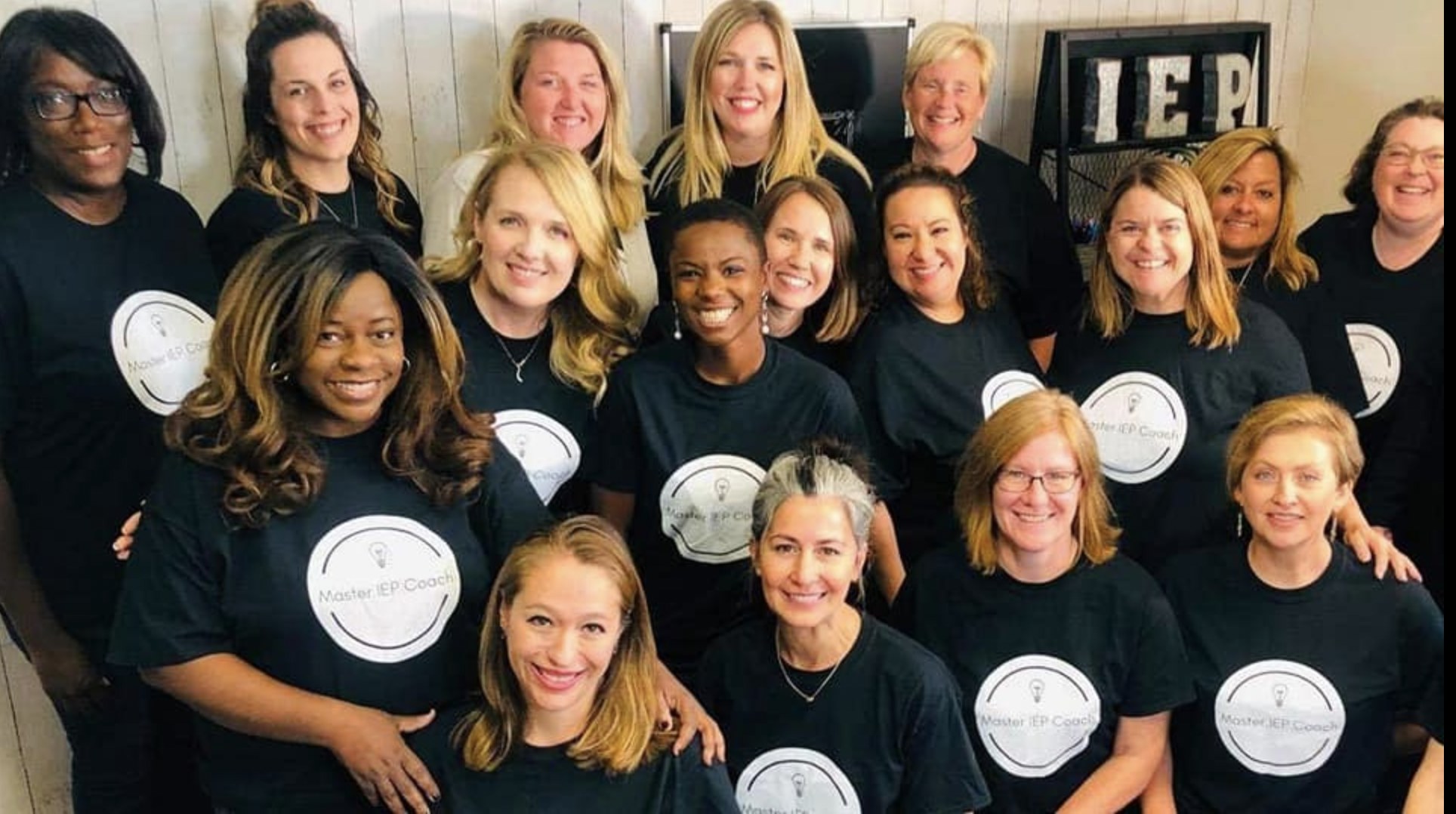 Fourteen Master IEP Coaches together in matching black tees