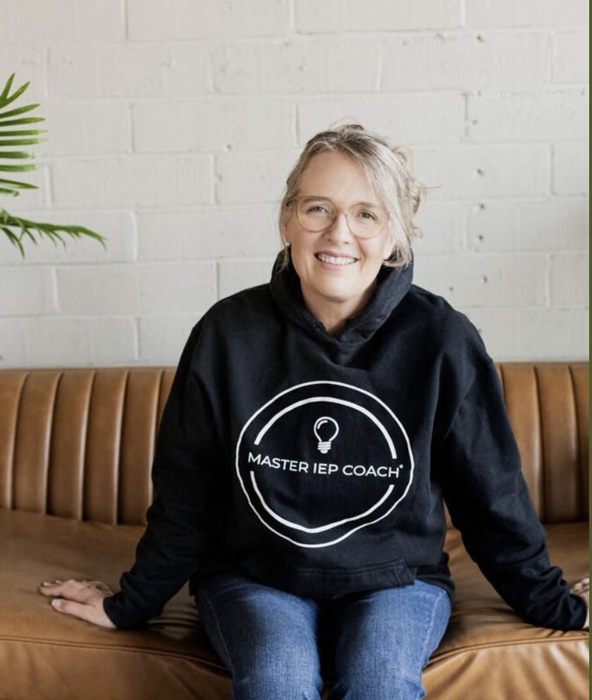 Catherine in her Master IEP Coach hoodie