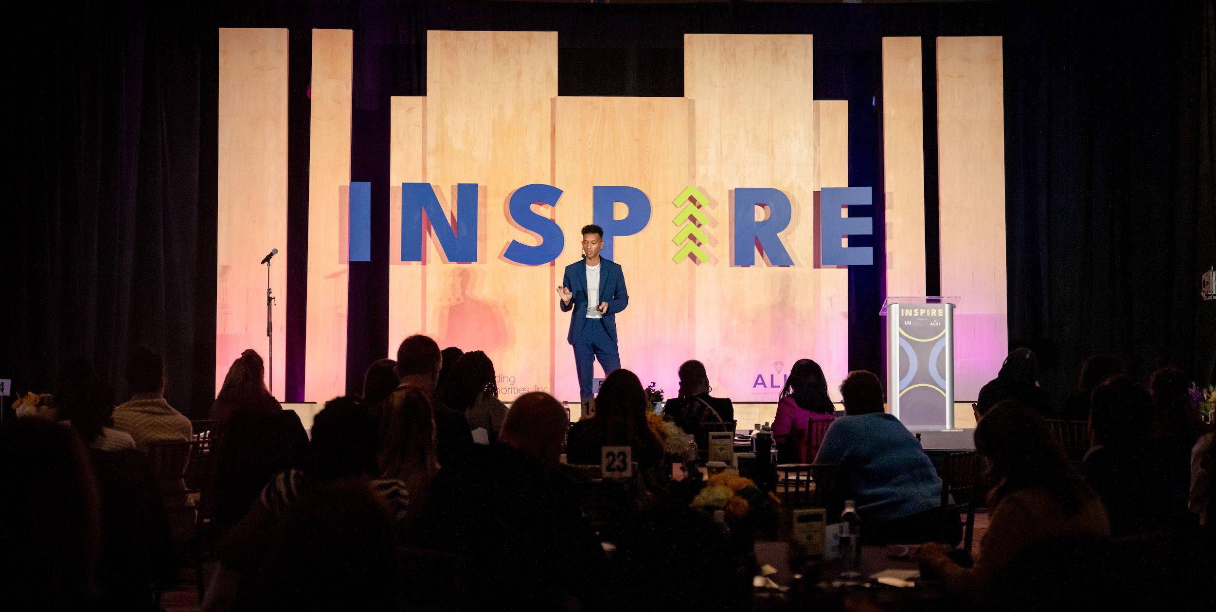 Justin Michael Williams delivering a keynote from the stage