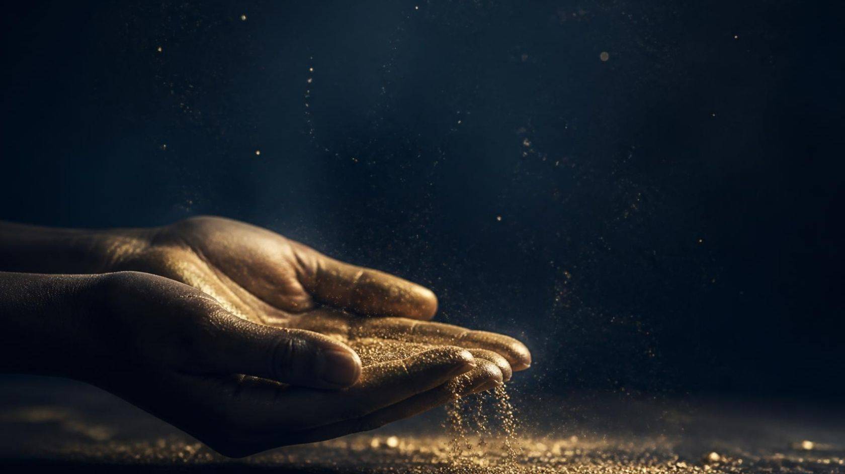 Hands holding gold dust