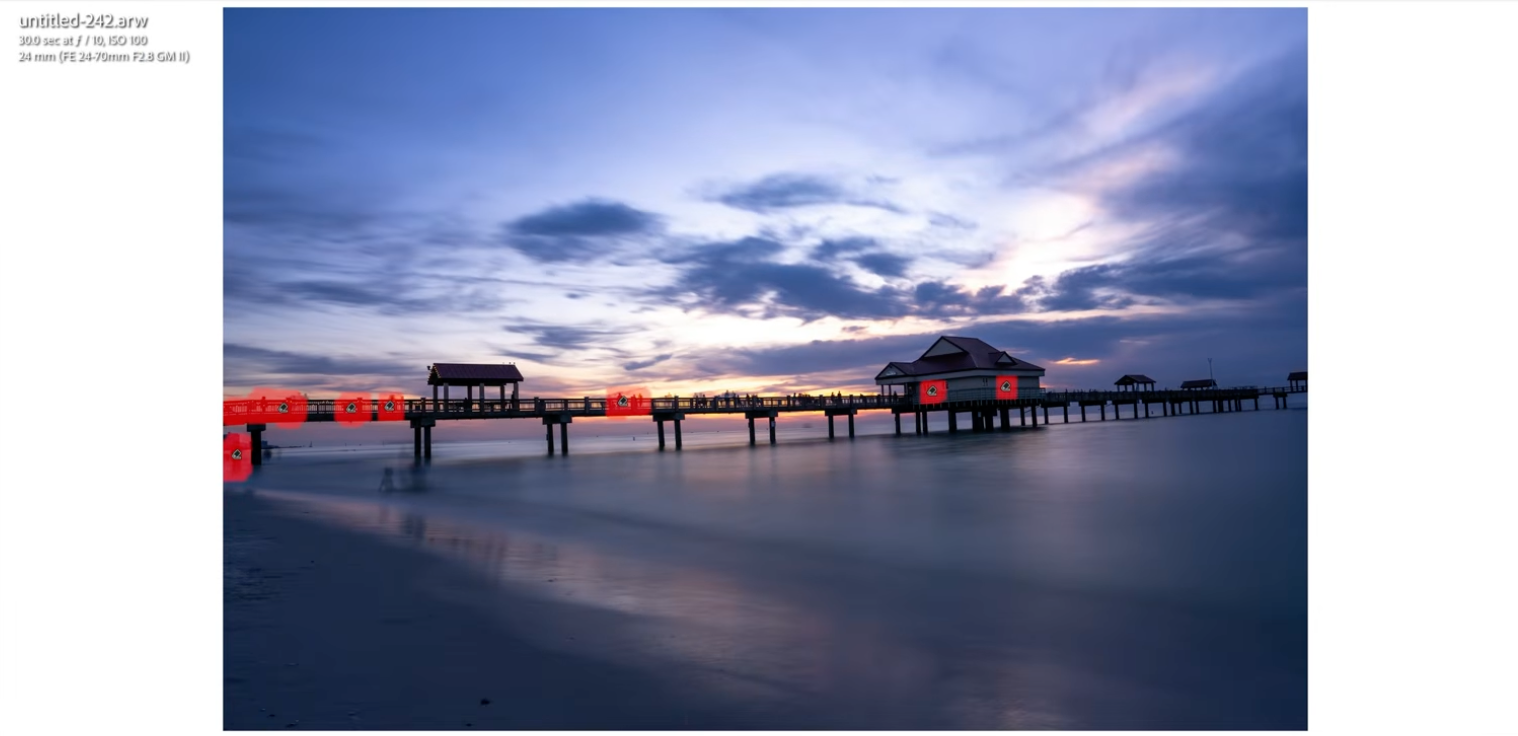 Lightroom detecting individual people on the pier with red markers for targeted removal