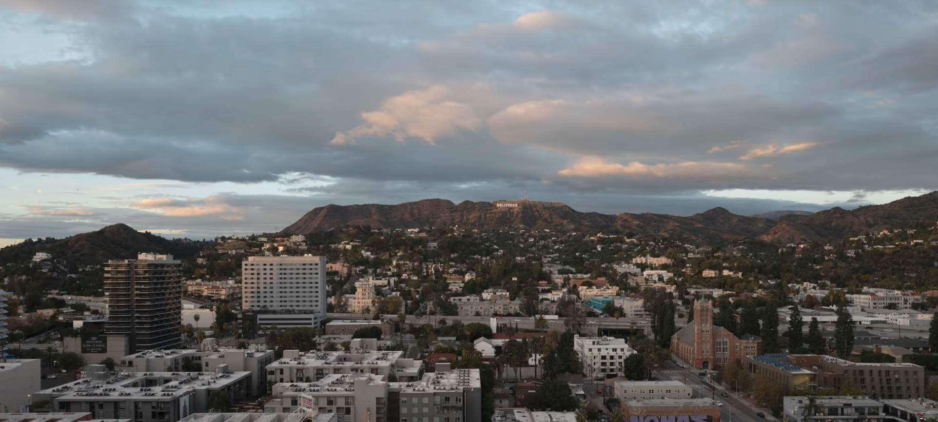 RAW, unedited photo of the Hollywood Sign small on the hillside, flat evening light