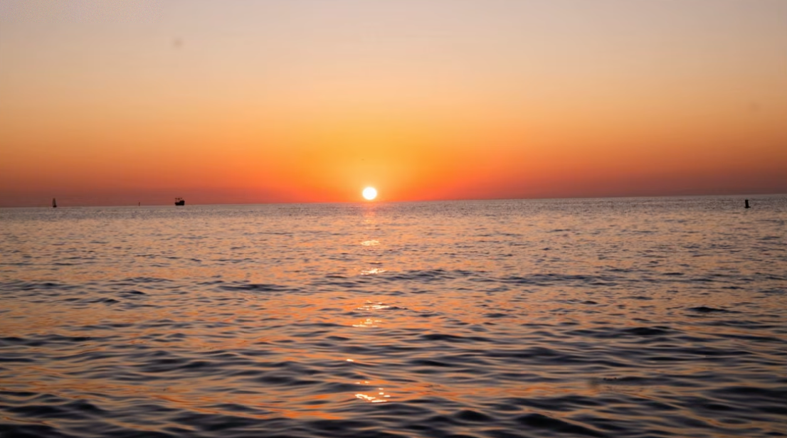 A boring, empty sunset over open water with nothing to anchor the composition