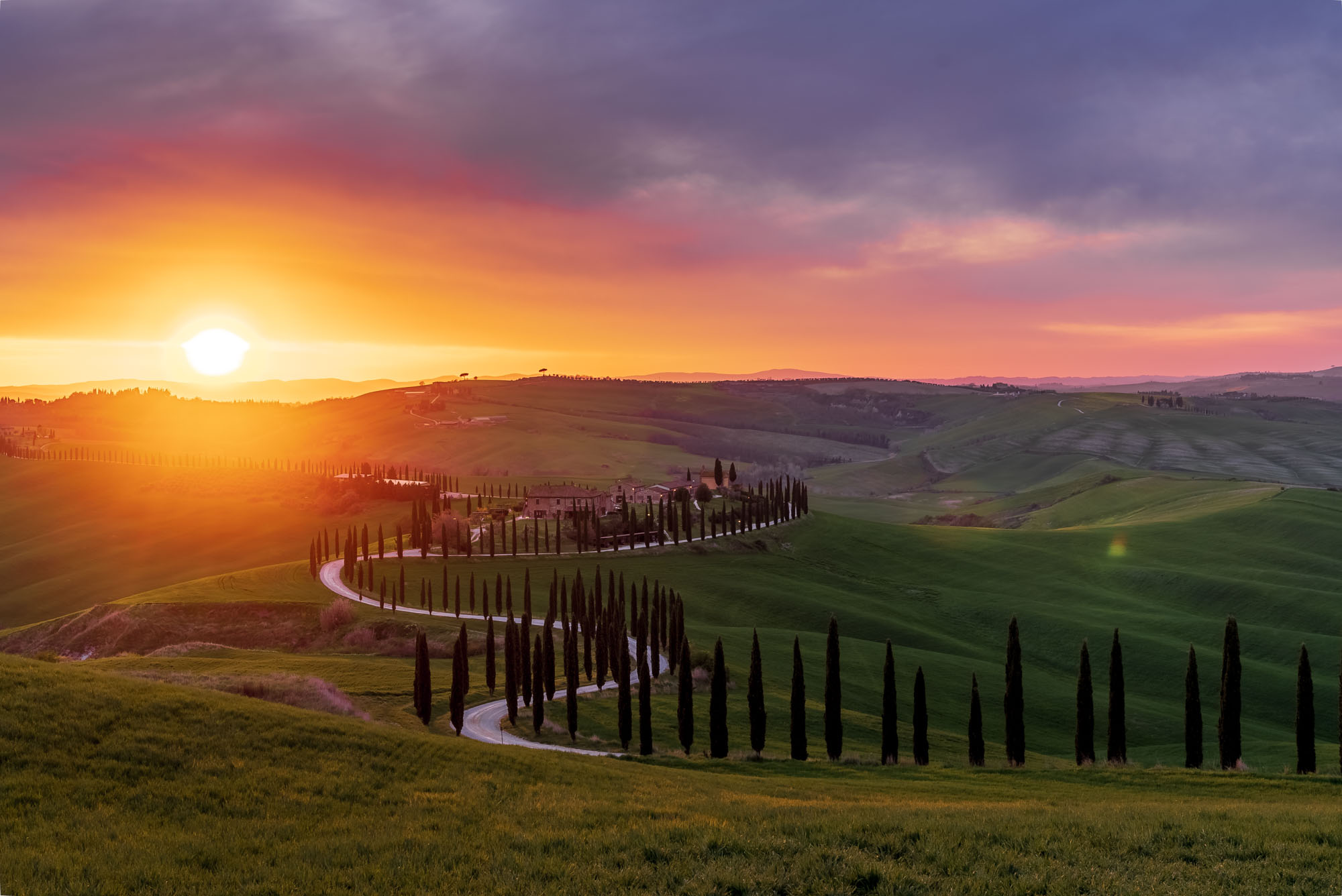 Sunset over rolling hills and cypress trees in Tuscany shot at ISO 100, f/8, 1/80s