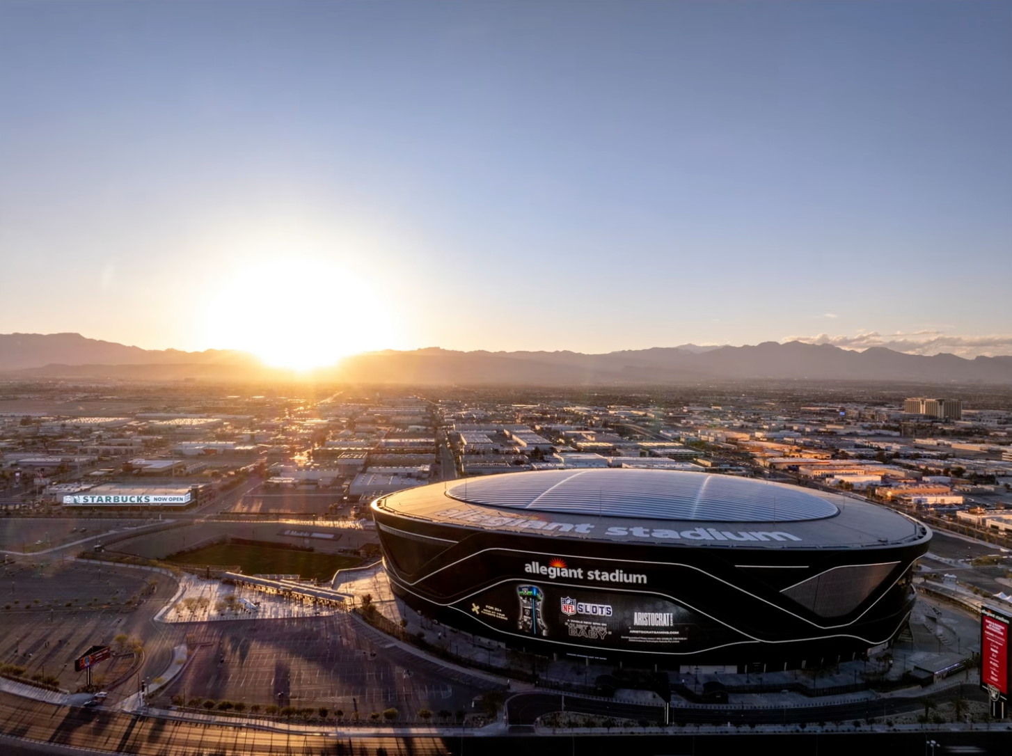 Allegiant Stadium in Las Vegas at sunset under a real, clear blue sky