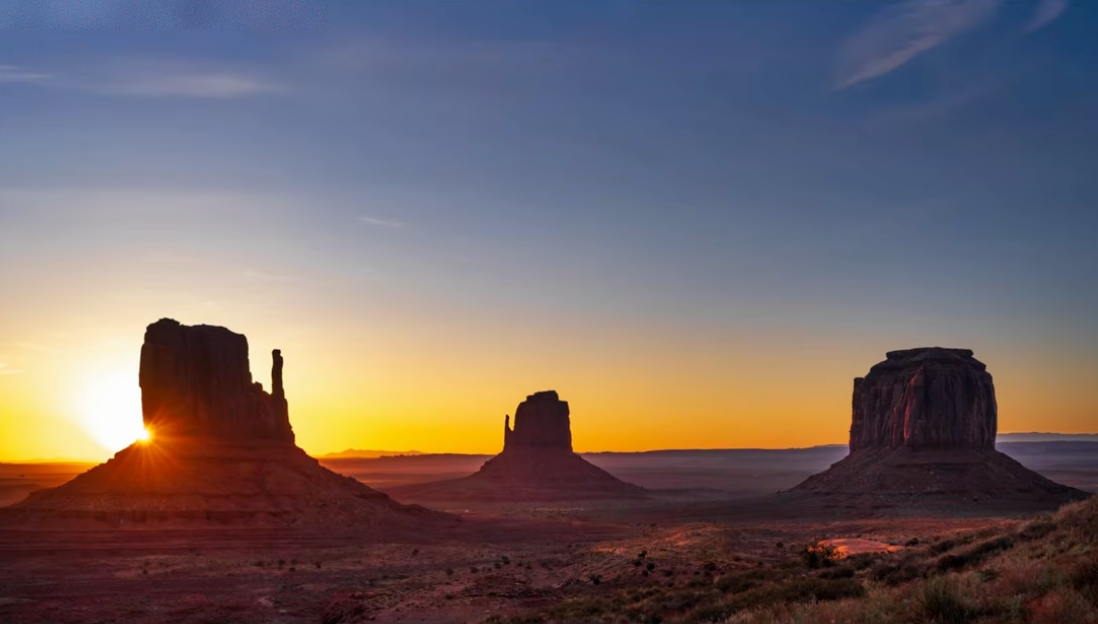 Monument Valley at sunrise with the horizon placed near the bottom of the frame, emphasizing the sky