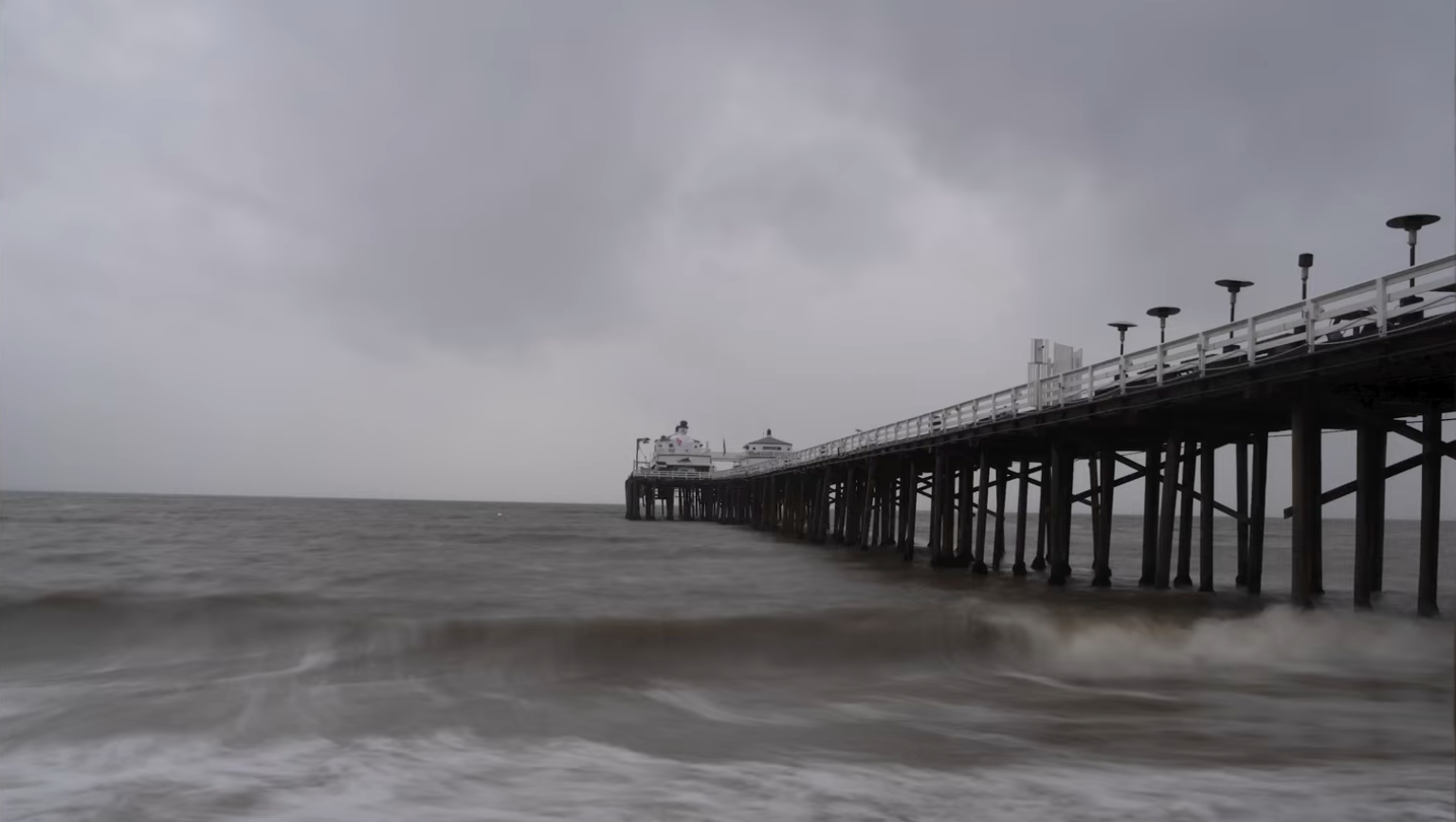 RAW, unedited long exposure of Malibu Pier under a stormy sky