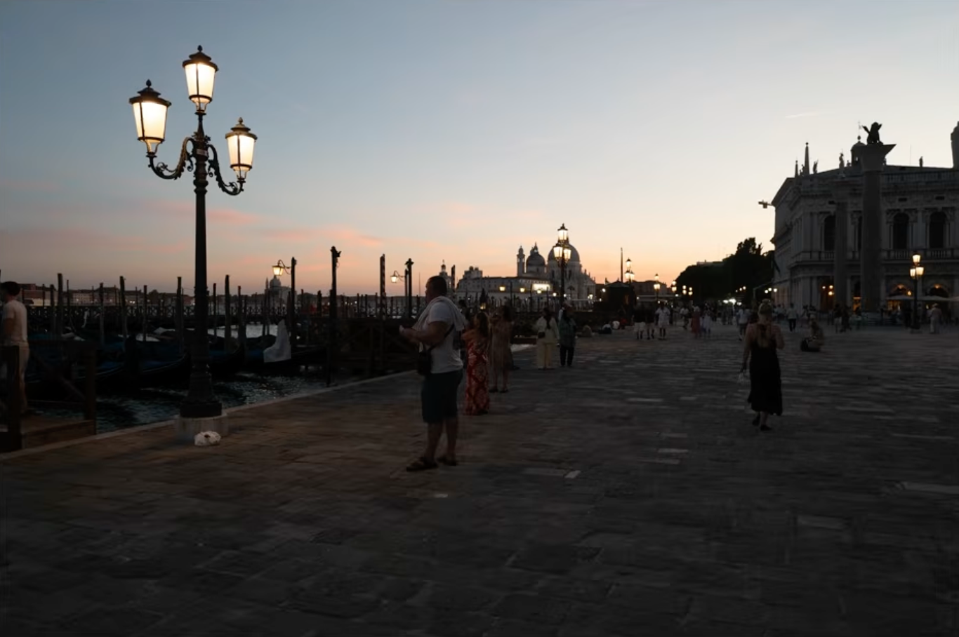 A crowded Venice promenade at sunset, full of tourists, before any editing