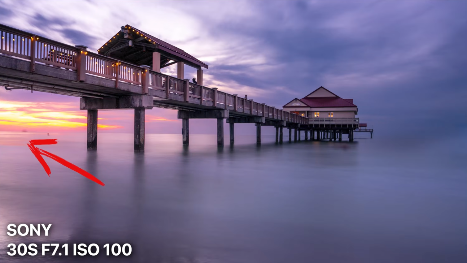 The same pier sunset photo reframed to include the sun, labeled as a stronger result