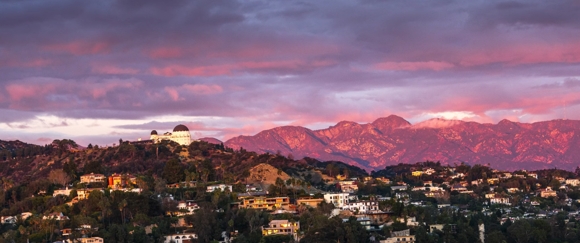Griffith Observatory with the San Gabriel Mountains glowing pink at sunset behind it, Los Angeles