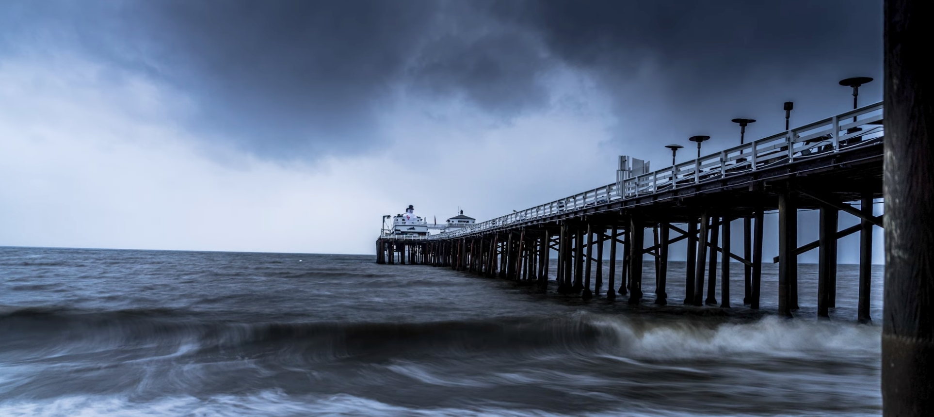 Malibu Pier at blue hour under a moody, stormy sky, long exposure, Los Angeles