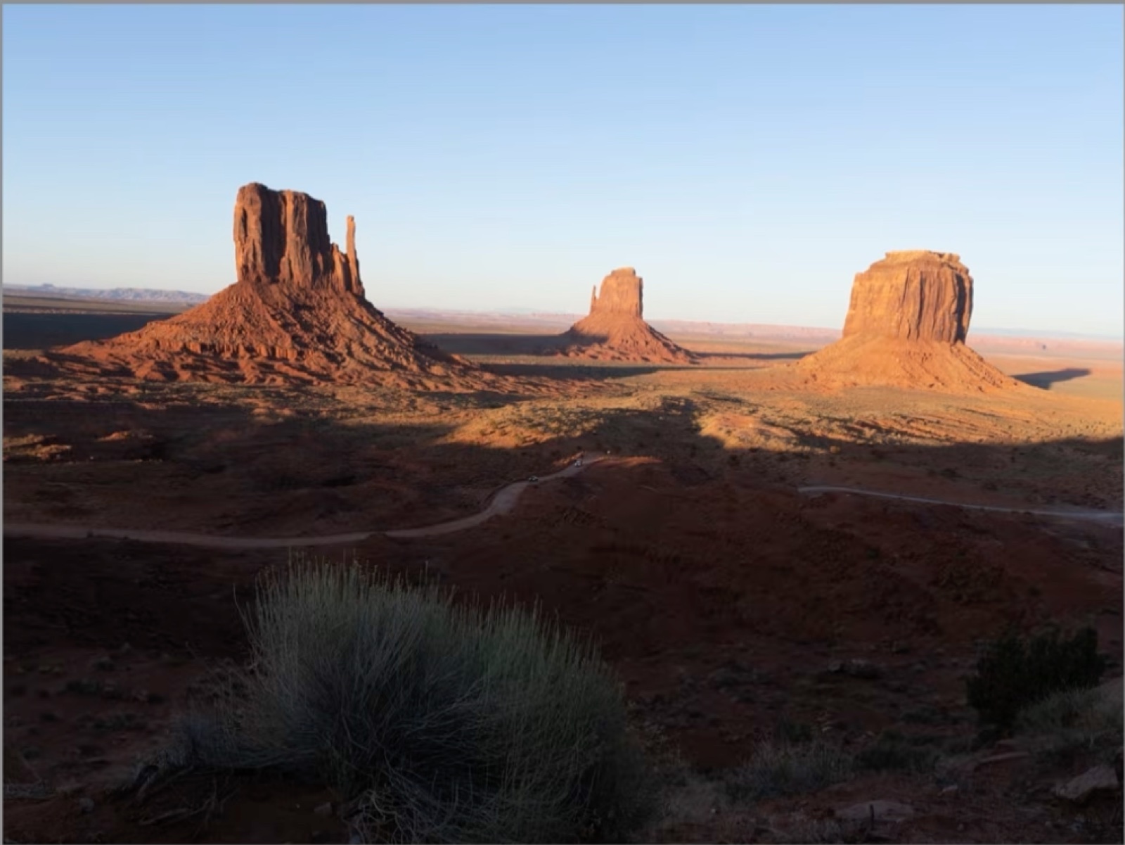 The flat, front-lit view of the Mittens at Monument Valley on the first evening