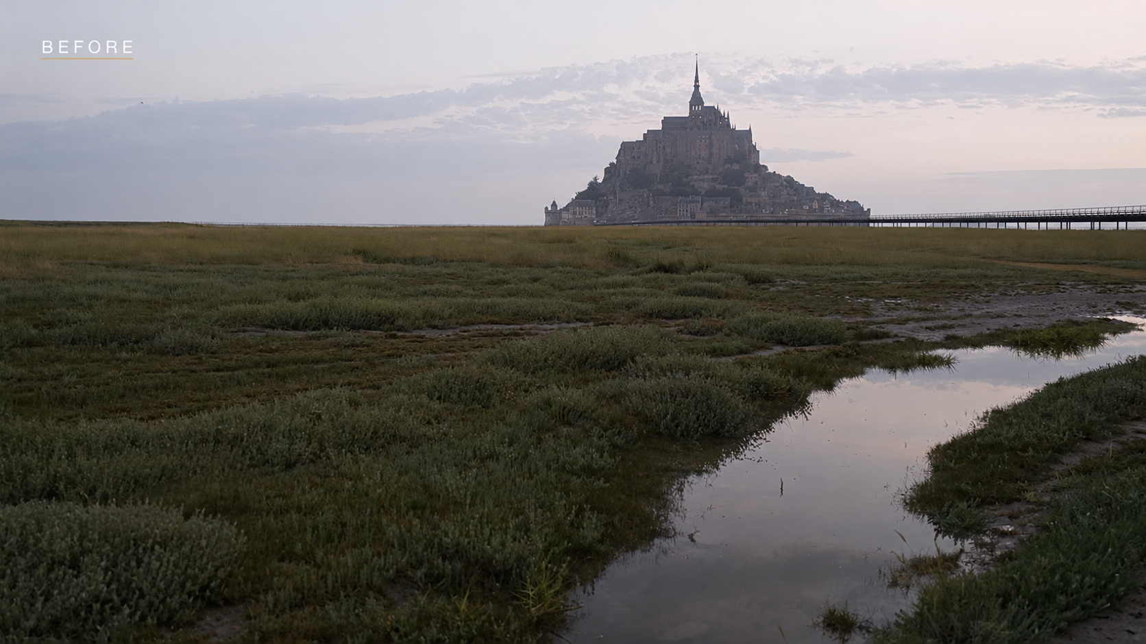 The flat, overexposed RAW file of Mont Saint-Michel before any adjustments in Luminar Neo