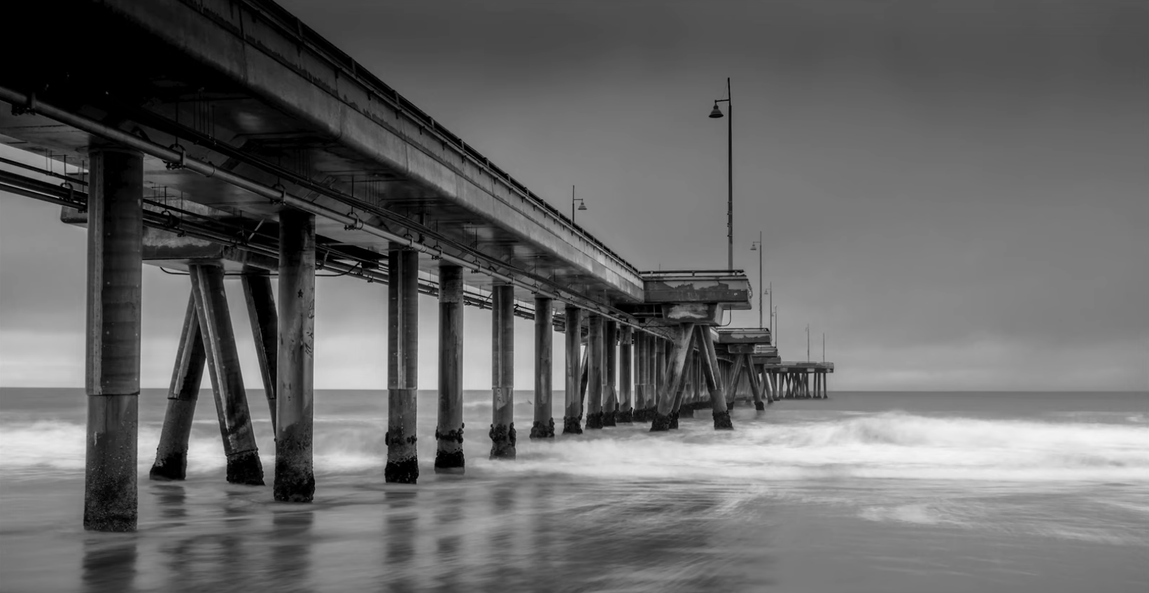 Venice Pier in black and white, long exposure smoothing the surf, Los Angeles