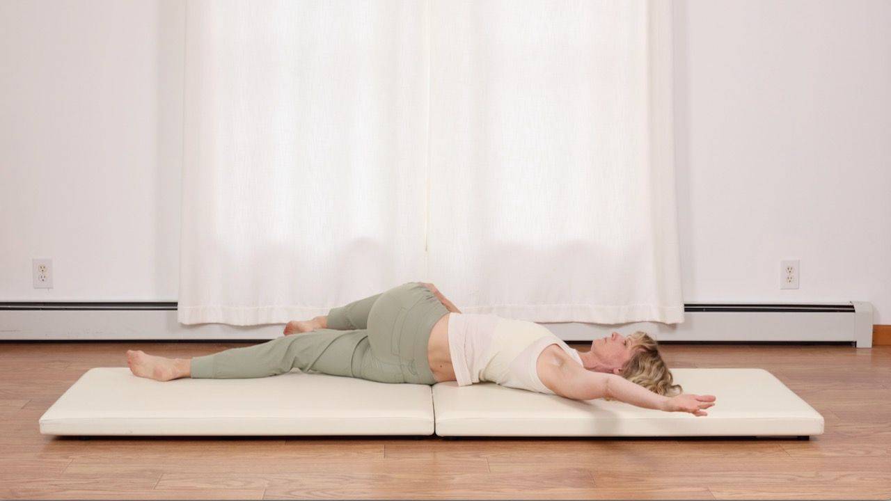 correcting the shoulder once the student is in the Pilates stretch