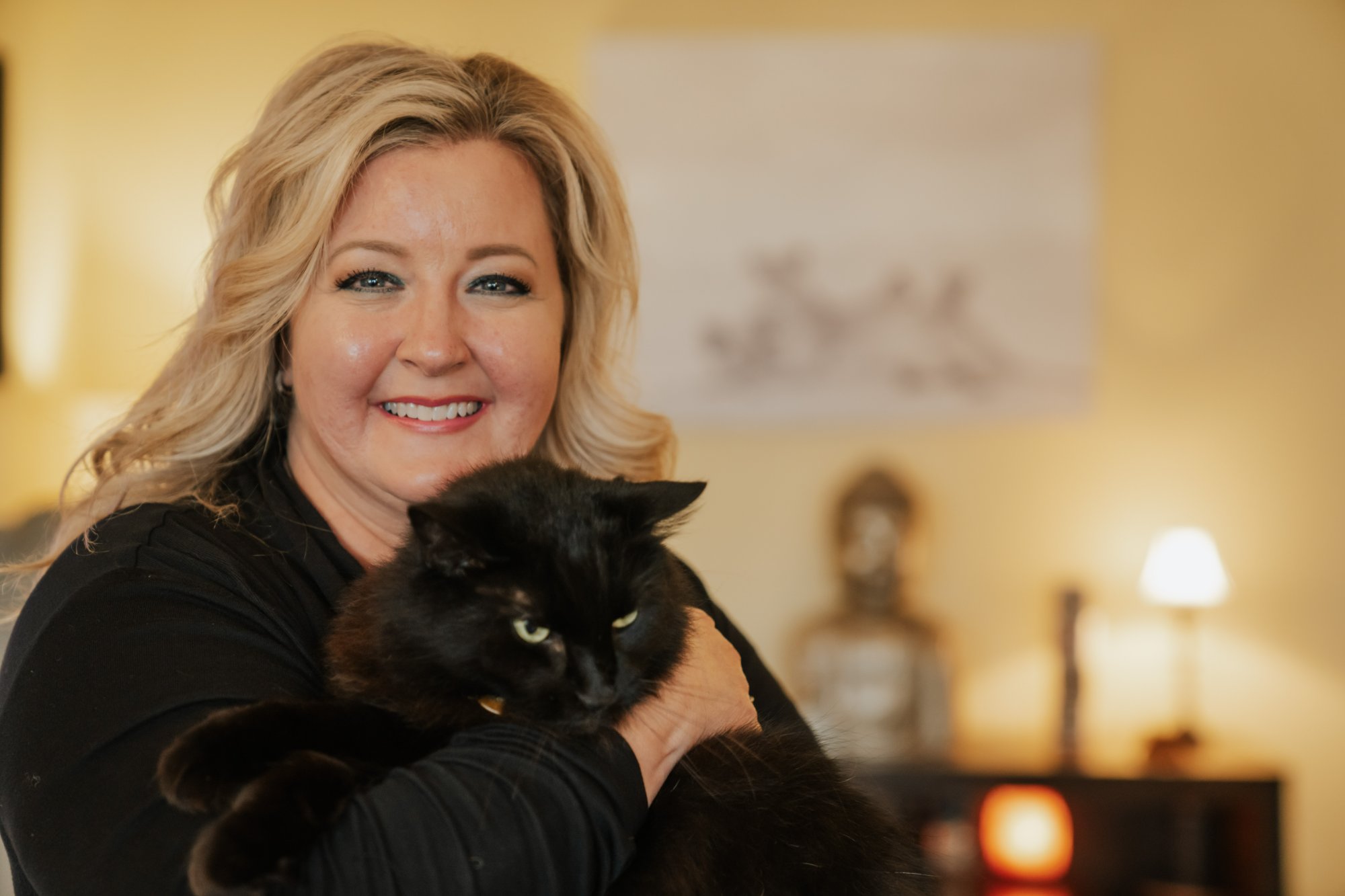 Shelby Carino holding her black cat