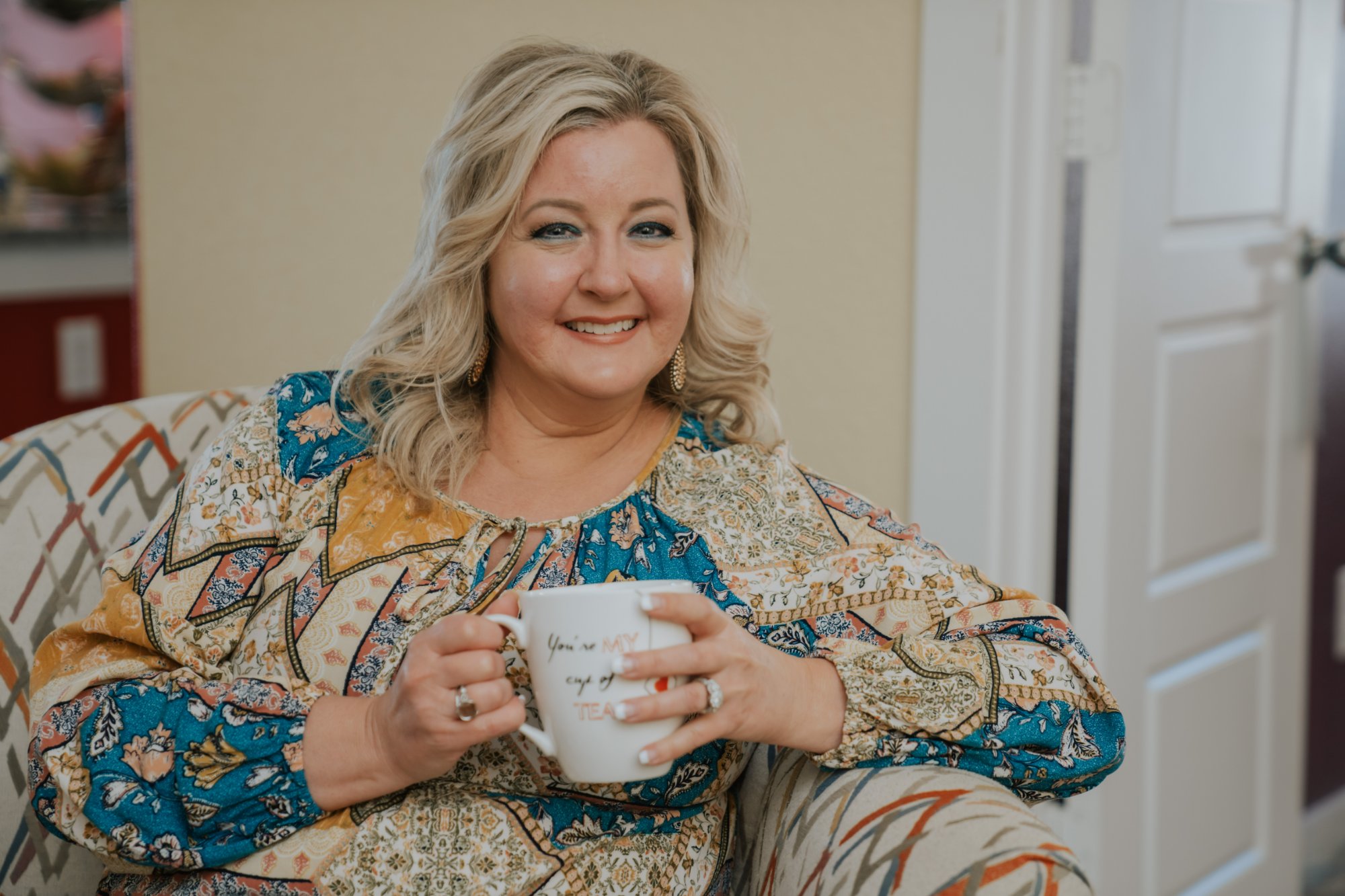 Shelby Carino smiling with a cup of tea