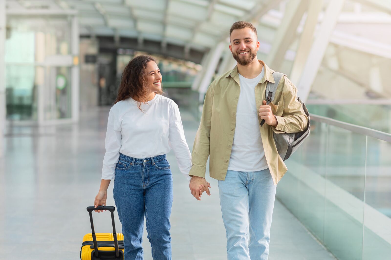 Couple walking together through an airport terminal – complex spousal sponsorship case in Canada