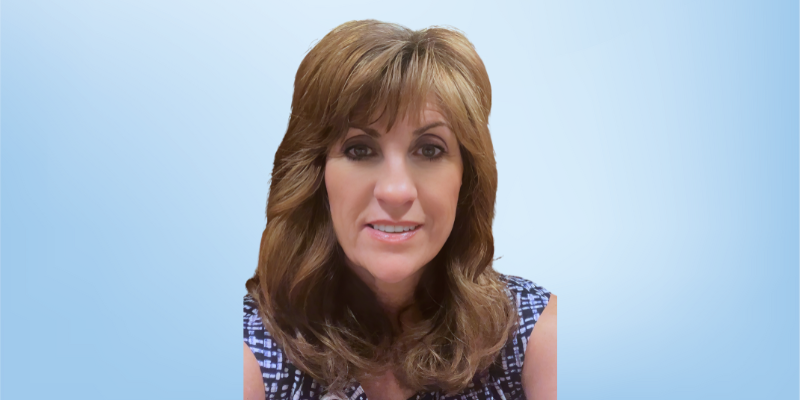 RaNae Wright, ethics advisor for the Healing Touch Program, photographed against a light blue background.