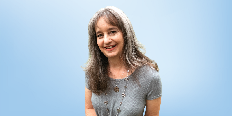 Lisa Gordon, CEO and owner of the Healing Touch Program, smiling against a light blue background.