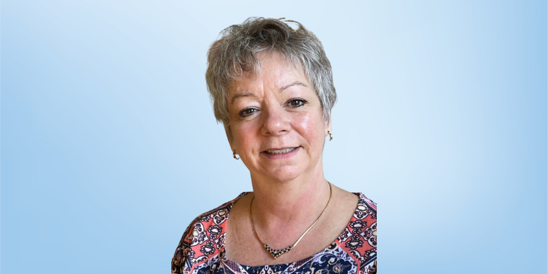 Donna Ackerman, curriculum review board member for the Healing Touch Program, smiling against a light blue background.