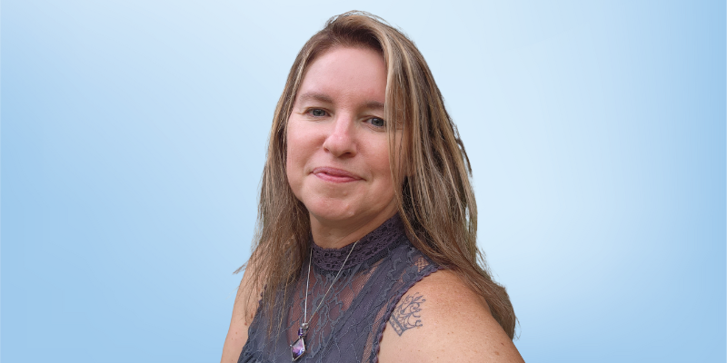 Jeanine Weise, client services administrator at the Healing Touch Program, smiling against a light blue background.