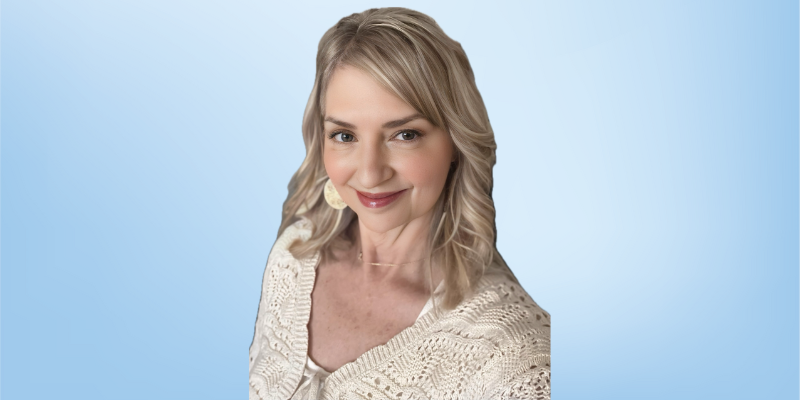 JoAnne Veith, integrative care program manager at the Healing Touch Program, smiling against a light blue background.