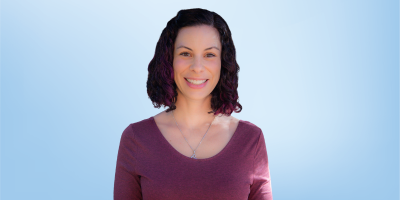Christine Salas, HTPA Community Director for the Healing Touch Program, smiling against a light blue background.