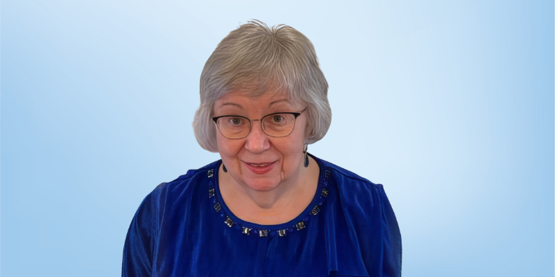 Ellen LaDieu, accredited provider program director at the Healing Touch Program, smiling against a light blue background.