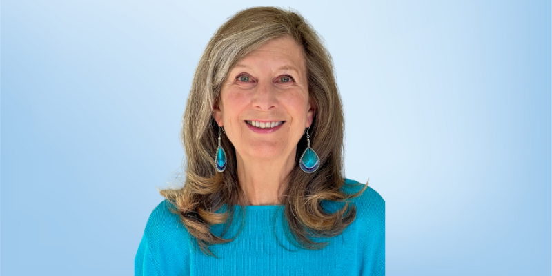 Nancy Lester, curriculum review board member for the Healing Touch Program, smiling against a light blue background.