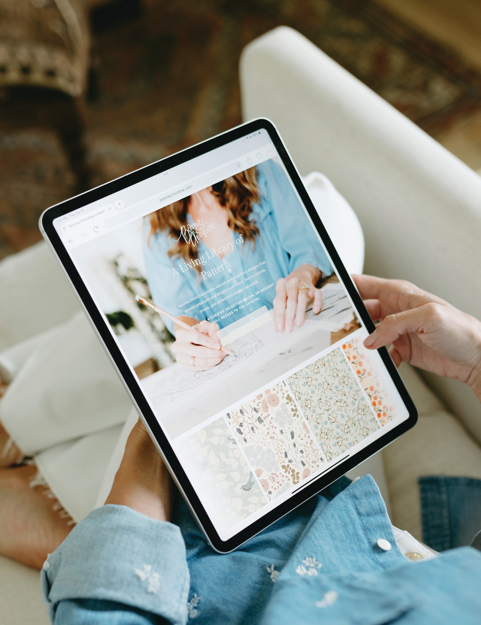Bonnie Christine's digital portfolio open on an iPad, held in her lap