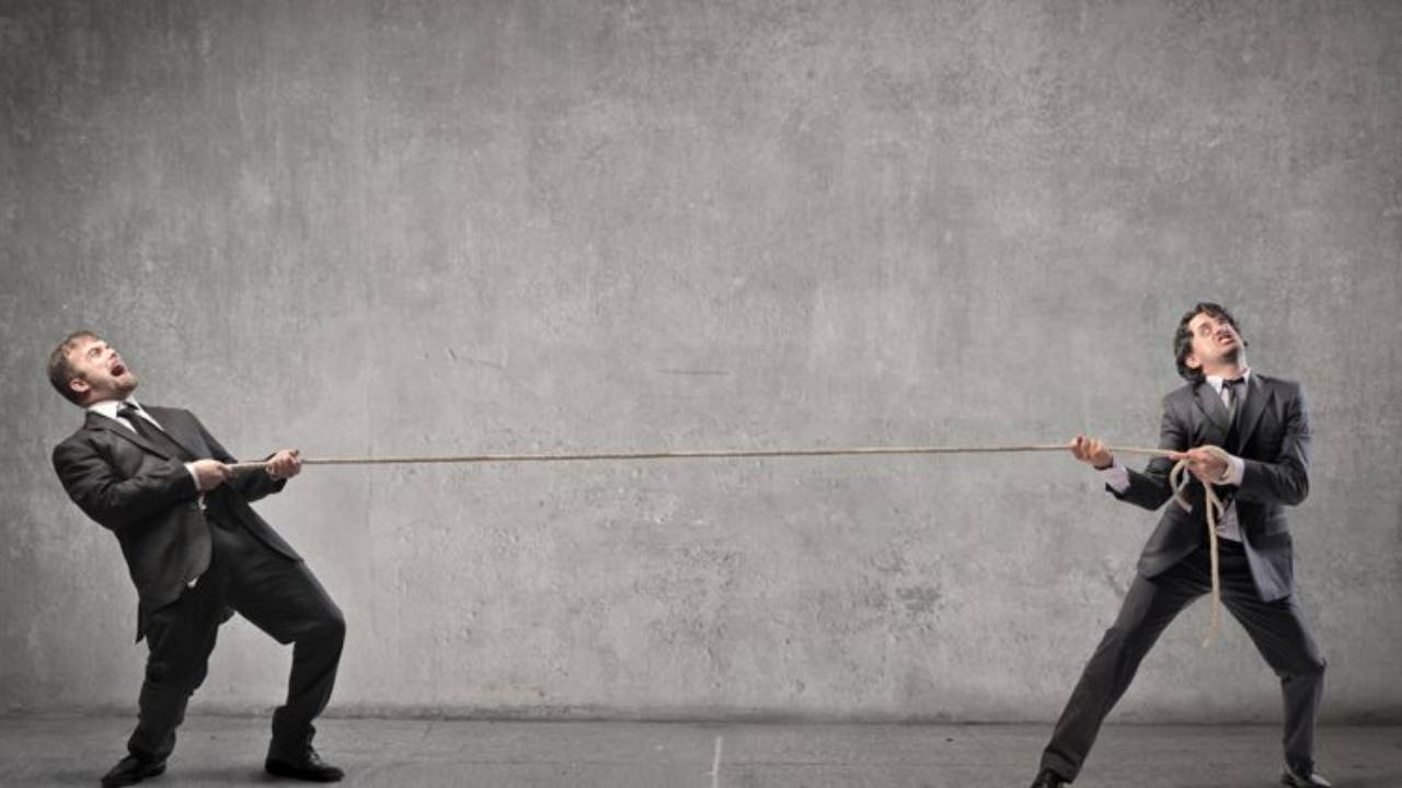 Two men struggling in tug-of-war