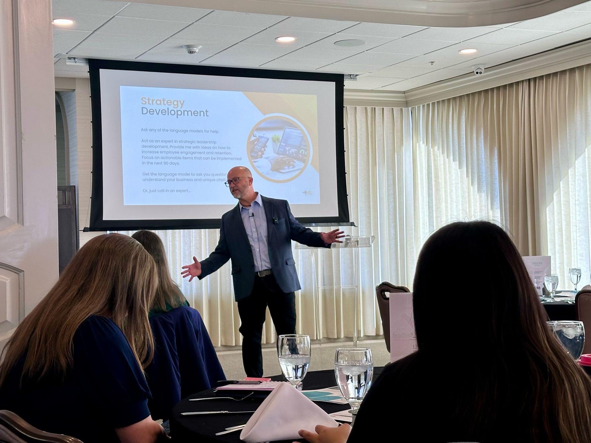 Jody Holland speaking to a room of leaders during a strategy development session