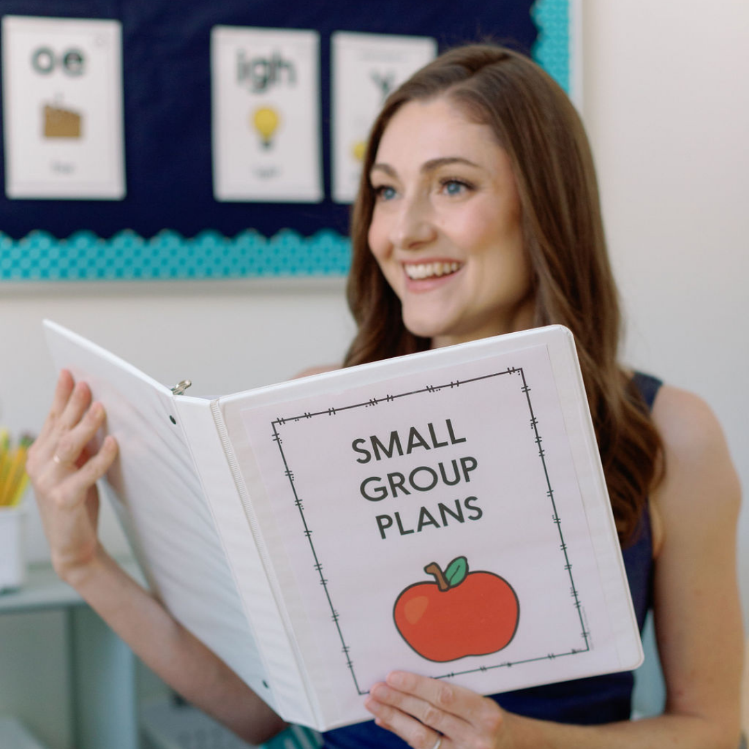 Alison Ryan, founder of Learning At The Primary Pond, holding a “Small Group Plans” binder used for small-group literacy instruction.
