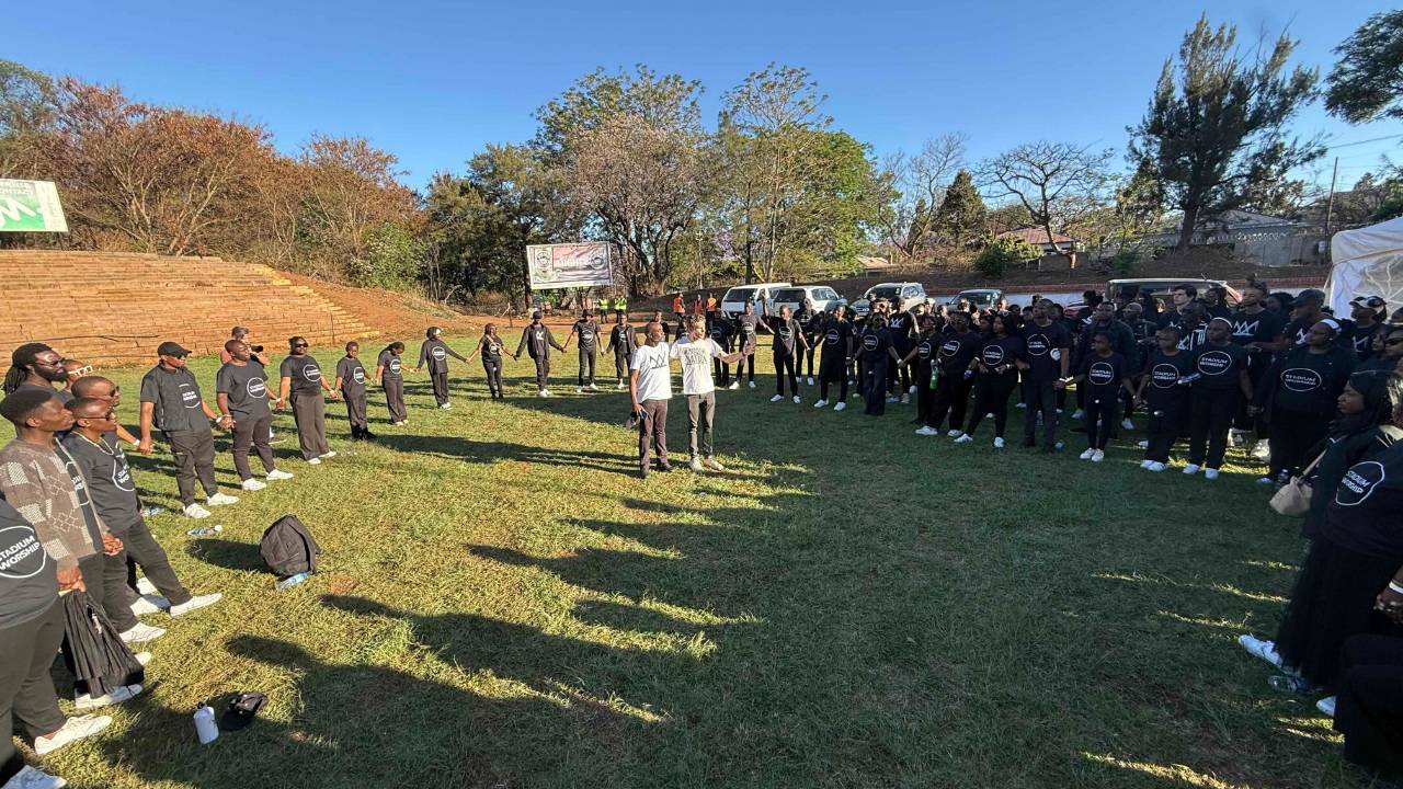 Stadium Worshippers praying in a circle