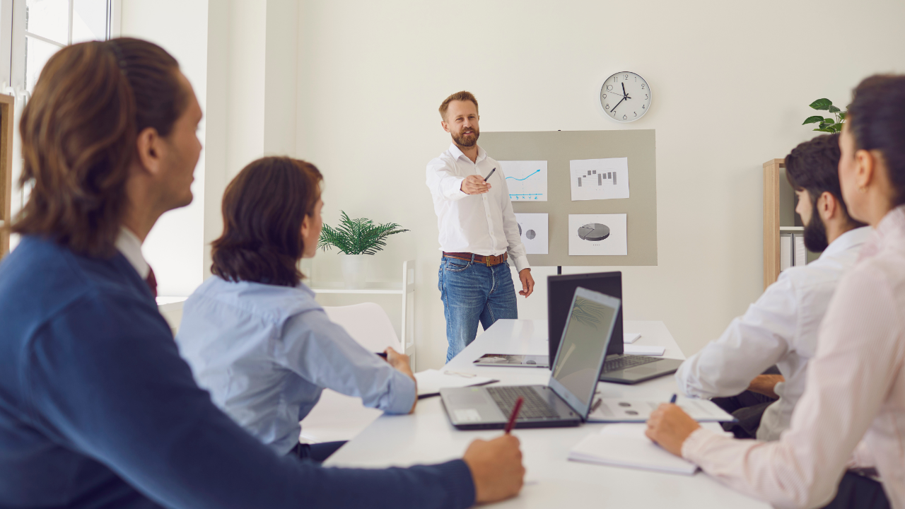 A professional executive coach leading a corporate leadership training workshop in Tampa, focusing on productivity and strategic focus.