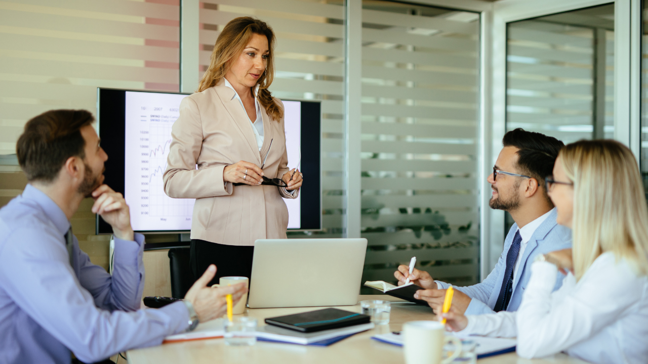 Close-up shot of a business executive listening intently during a leadership development workshop or corporate meeting.