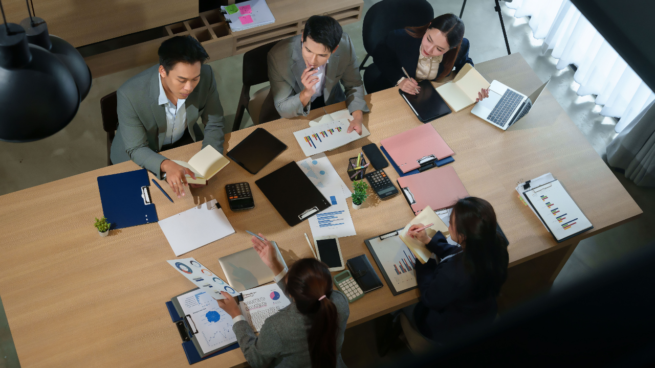 Leader engaging employees in a collaborative in-person workplace discussion